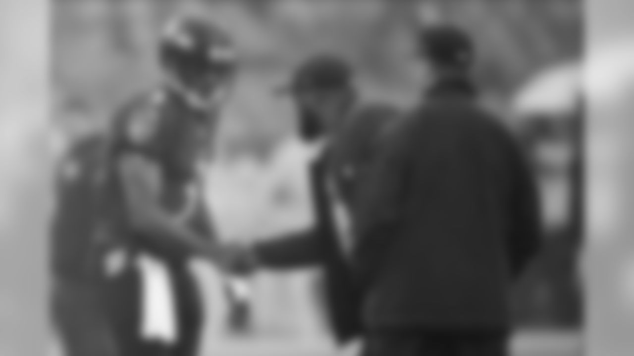 Baltimore Ravens quarterback Robert Griffin III, left, shakes hands with Pittsburgh Steelers head coach Mike Tomlin, center, as Ravesn head coach John Harbaugh looks on prior to an NFL football game, Sunday, Dec. 29, 2019, in Baltimore. (AP Photo/Nick Wass)