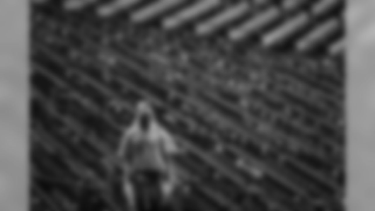 A worker walks through the stands as rain delays a preseason NFL football game between the Philadelphia Eagles and the Baltimore Ravens, Thursday, Aug. 22, 2019, in Philadelphia. (AP Photo/Michael Perez)