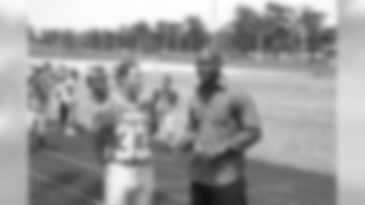 CB Chris McAlister talks to a member of the Mervo High School football team at the conclusion of the groundbreaking ceremony.