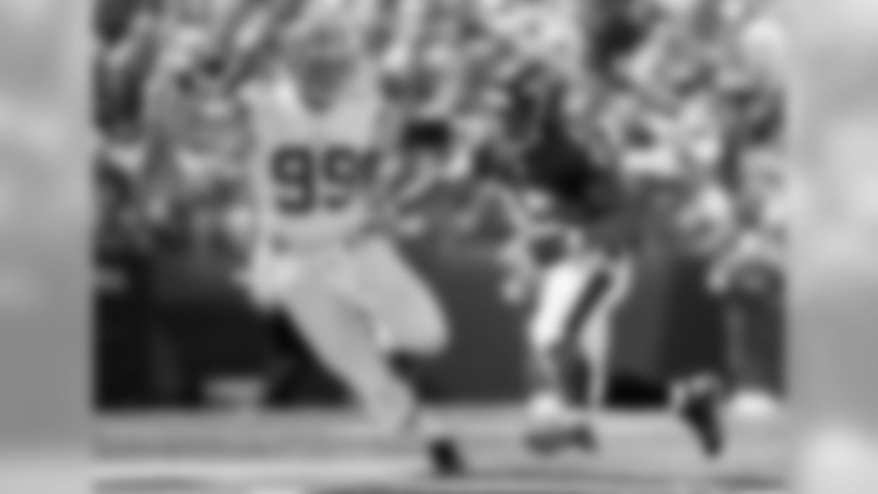 Running back Ray Rick looks to get upfield with former Raven Paul Kruger in pursuit.