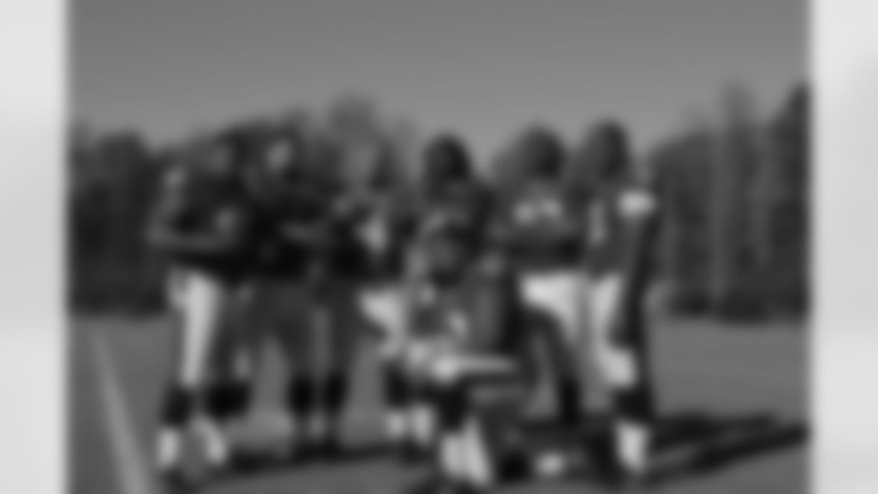 The defensive linemen having some fun with their photo.