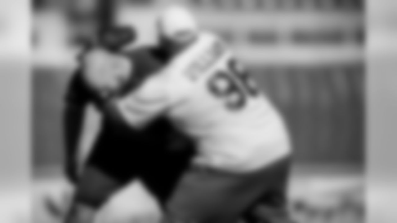 Defensive lineman Brandon Williams grabs center Gino Gradkowski after a home run by Gradkowski.