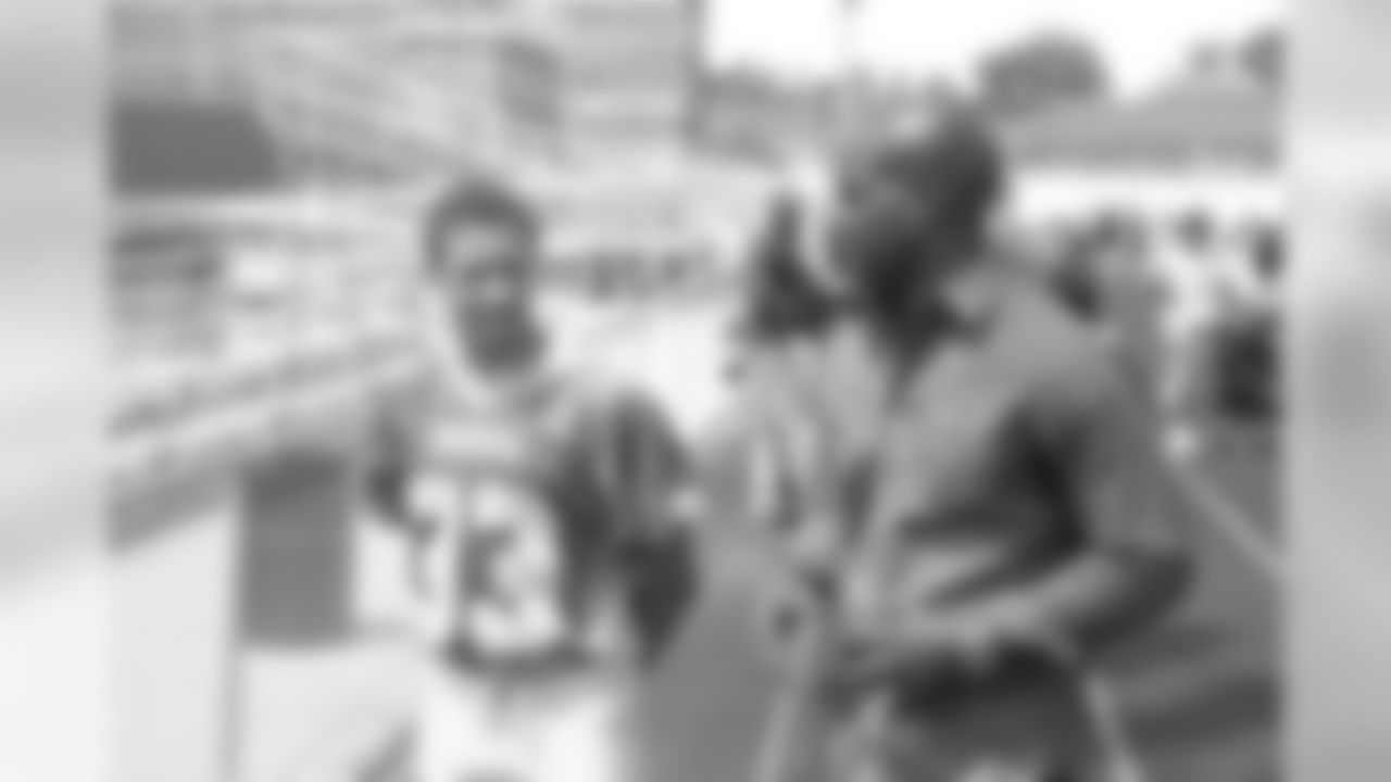 CB Chris McAlister talks to a member of the Mervo High School football team at the conclusion of the groundbreaking ceremony.