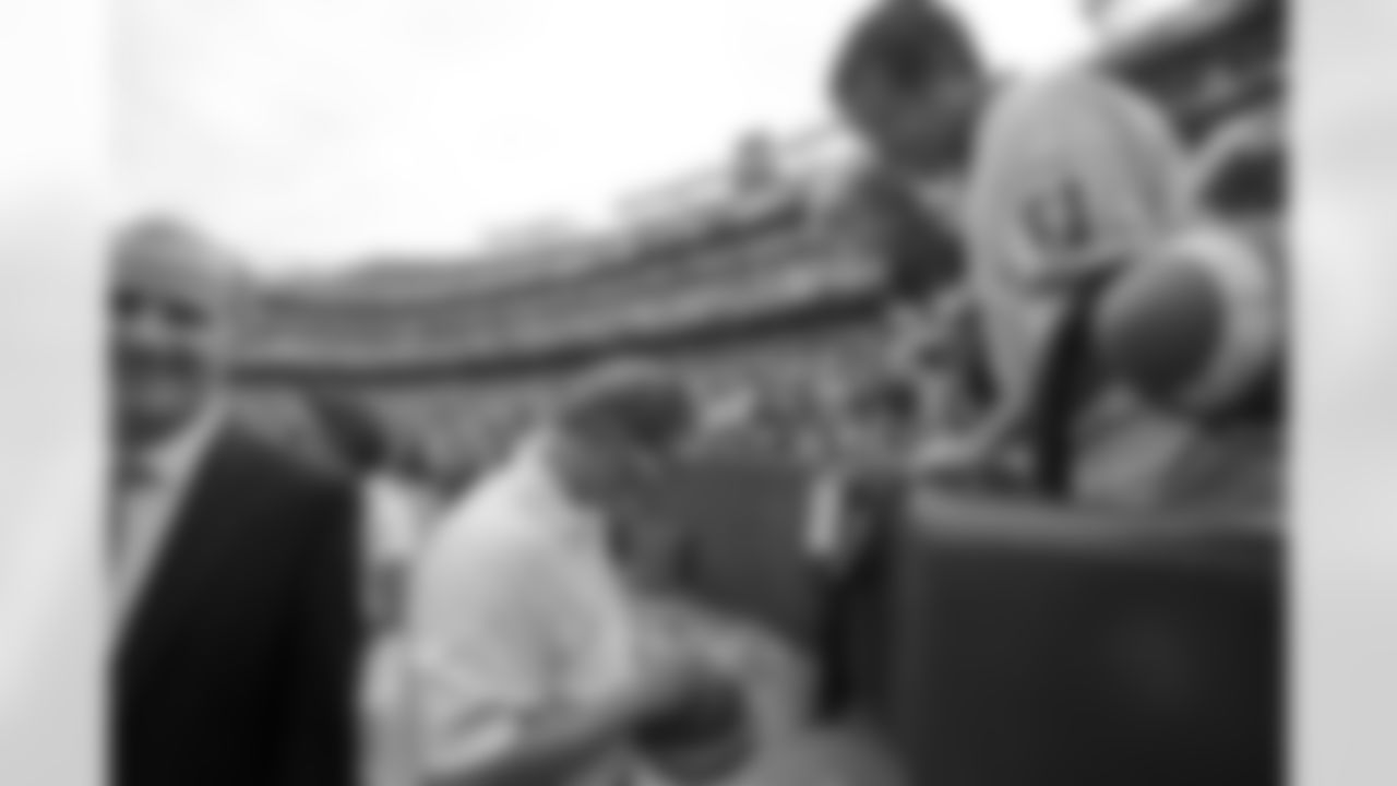 Joe Theismann signs autographs for fans at halftime of the Redskins-Cardinals game.