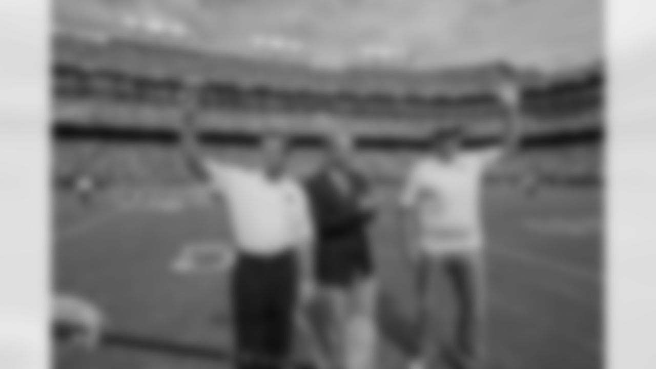 (Left to Right) Joe Theismann, NRG CEO David Crane, and Mark Rypien during the official "flipping of the switch" at halftime. The ceremony inagurated the new NRG solar power installation at FedExField.