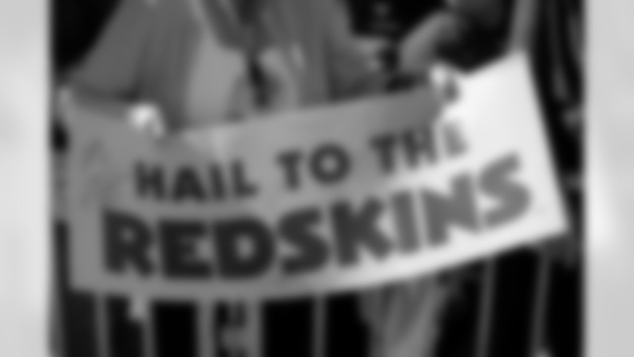 Redskin fans hold up a sign to support their team.
