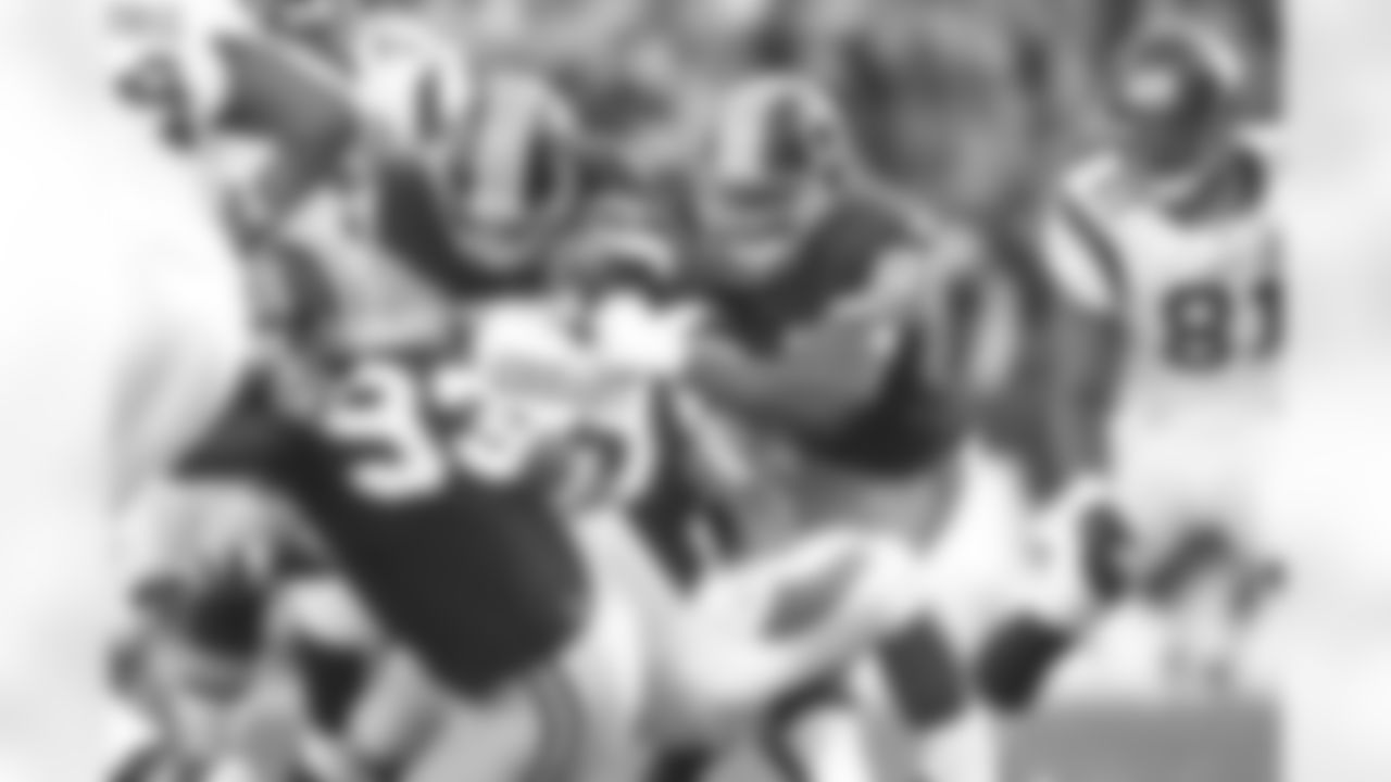 Andre Carter and Adam Carriker wrap up Toby Gerhart. (Ned Dishman)