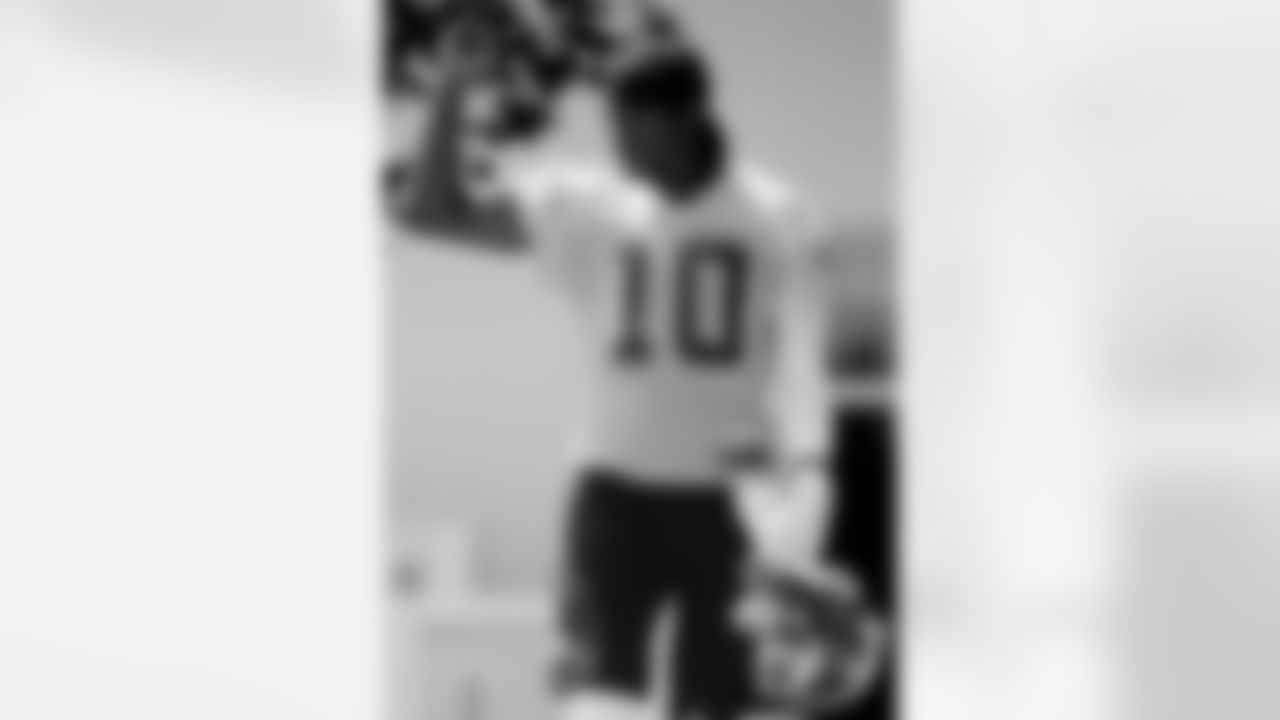Walking down to practice, QB Robert Griffin III interacts with fans yelling his name.