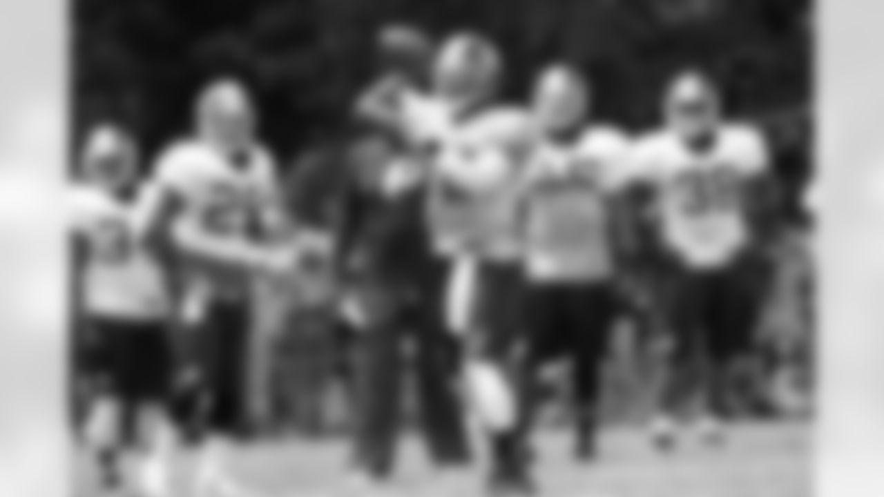 Redskins QB Robert Griffin III throws a pass during practice on Fan Appreciation Day