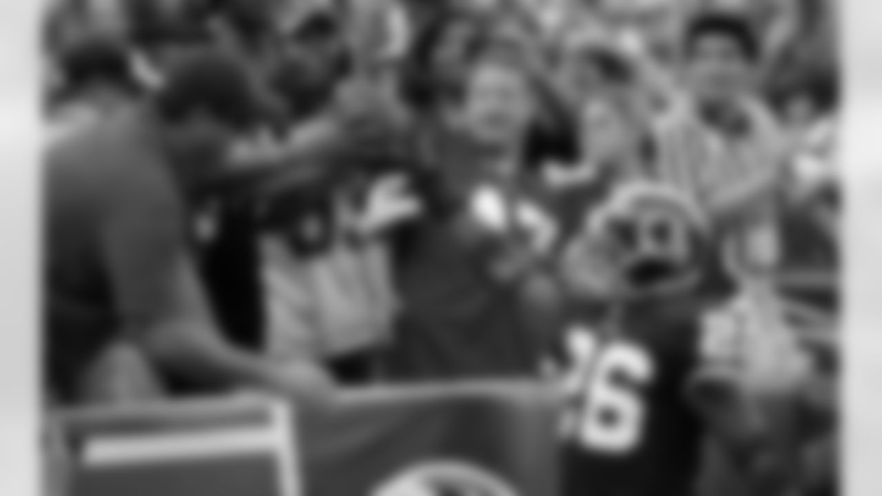 Clinton Portis gives a game ball to fans after scoring a touchdown. (AP Photo)