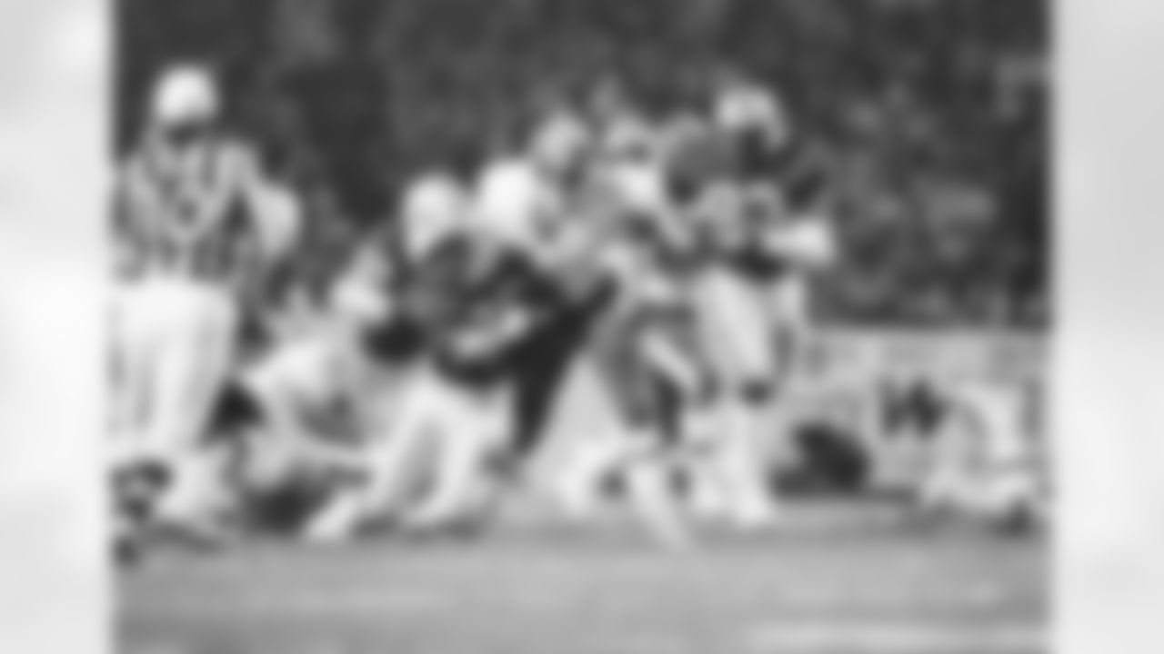 Washington Redskins punt receiver Mike Nelms gives Green Bay defensive back Tim Lewis a tough time on the tackle attempt before breaking loose on a long kickoff return in first quarter NFL action in Green Bay, Wisc., Oct. 17, 1983. giving chase is Packers defensive end Robert Brown. (AP Photo/Jim Mone)