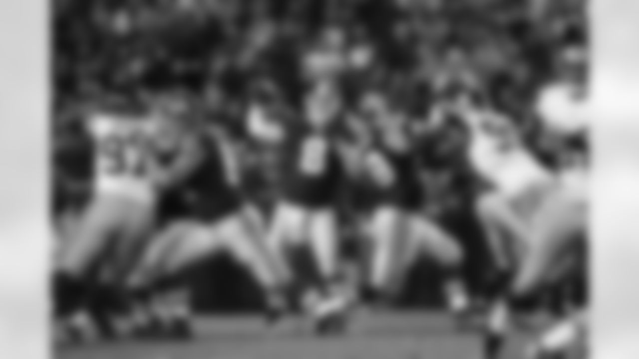 Rex Grossman passes the ball under pressure. (Ned Dishman)