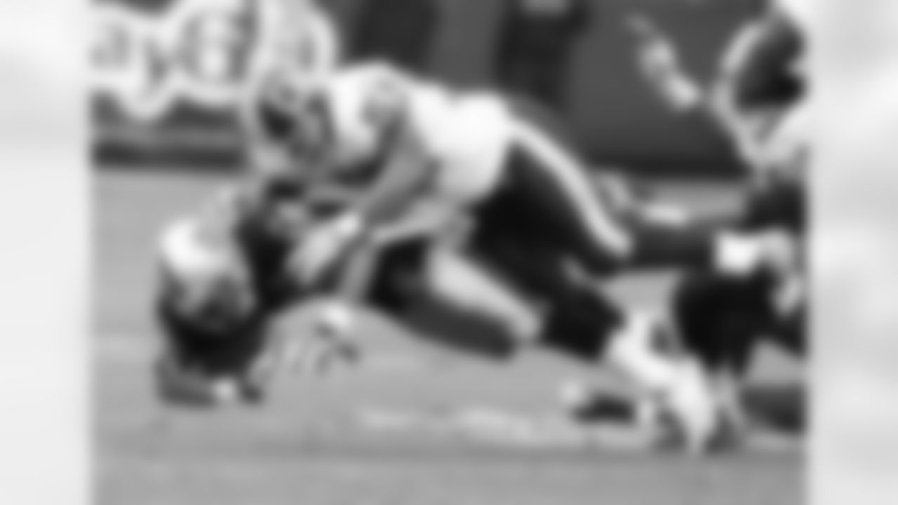 Linebacker London Fletcher makes a tackle against a Raiders player in Oakland.