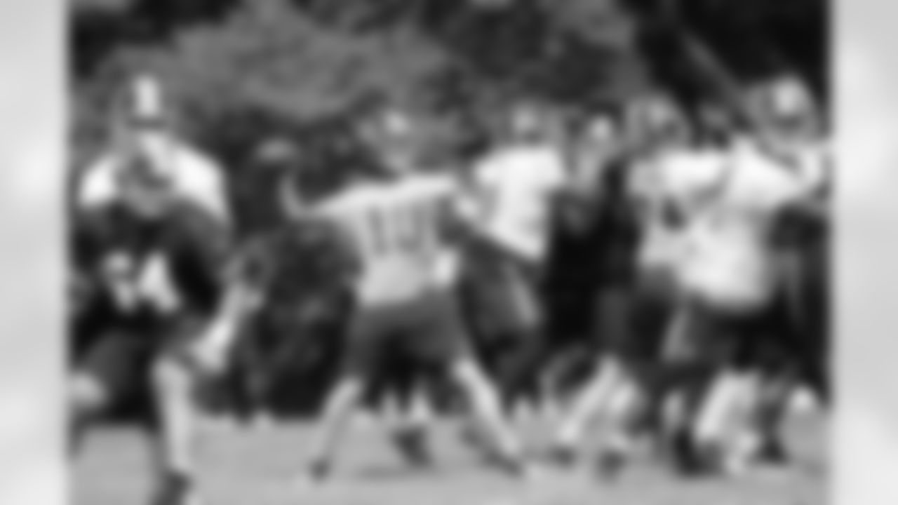 Redskins quarterback Robert Griffin III throws the ball downfield during full-team drills at Redskins mini-camp.