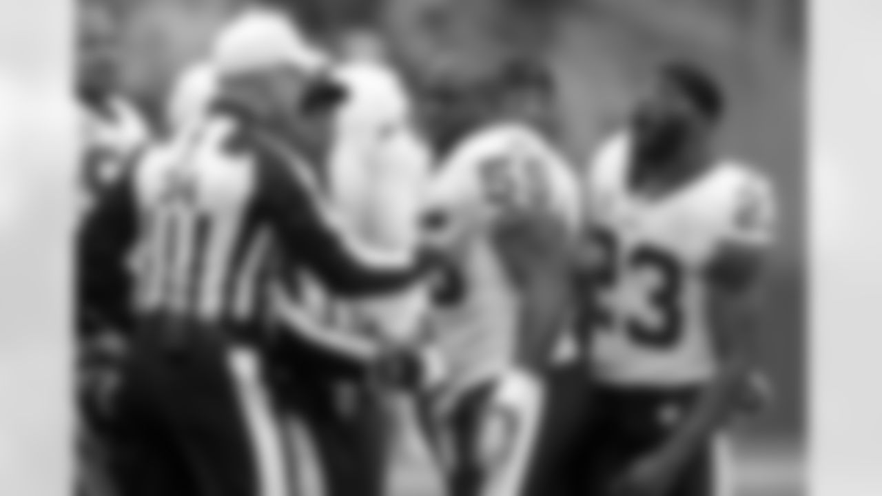 London Fletcher and DeAngelo Hall exchange words with Seahawks players during the coin toss.