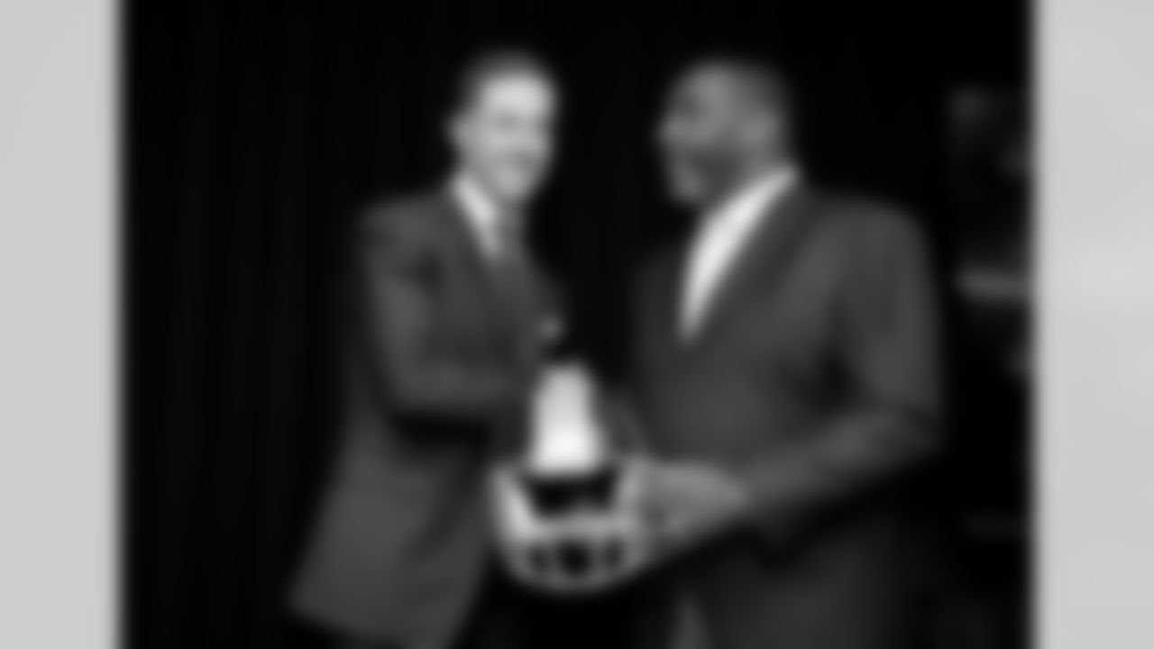 In this March 15, 2018, file photo, newly signed Washington quarterback Alex Smith, left, shakes hands and poses with Doug Williams during a news conference in Ashburn, Va. (AP Photo/Nick Wass, File)