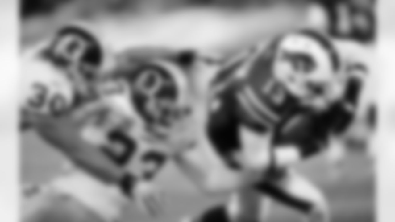 LaRon Landry and DeAngelo Hall try to take down Bills wide receiver Stevie Johnson.
