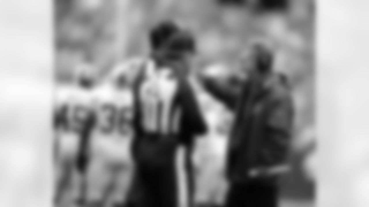 Head coach Mike Shanahan speaks with officials at Lambeau Field on Sunday, Sept. 15, 2013, in Green Bay, Wis.