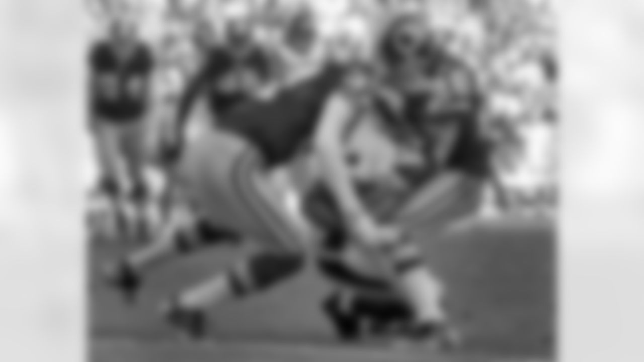 Reed Doughty and Josh Wilson tackle wide receiver Percy Harvin.