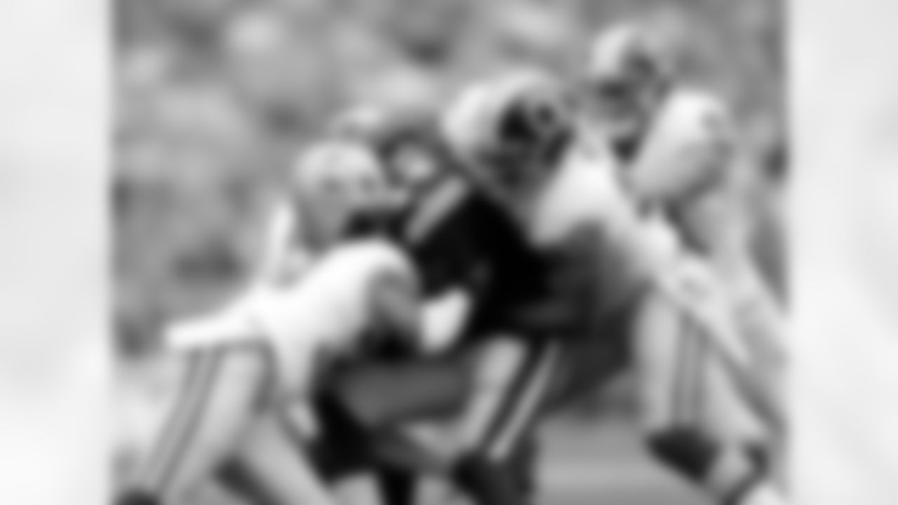 Linebacker Perry Riley Jr. is one of four Redskins defenders taking down running back James Starks.