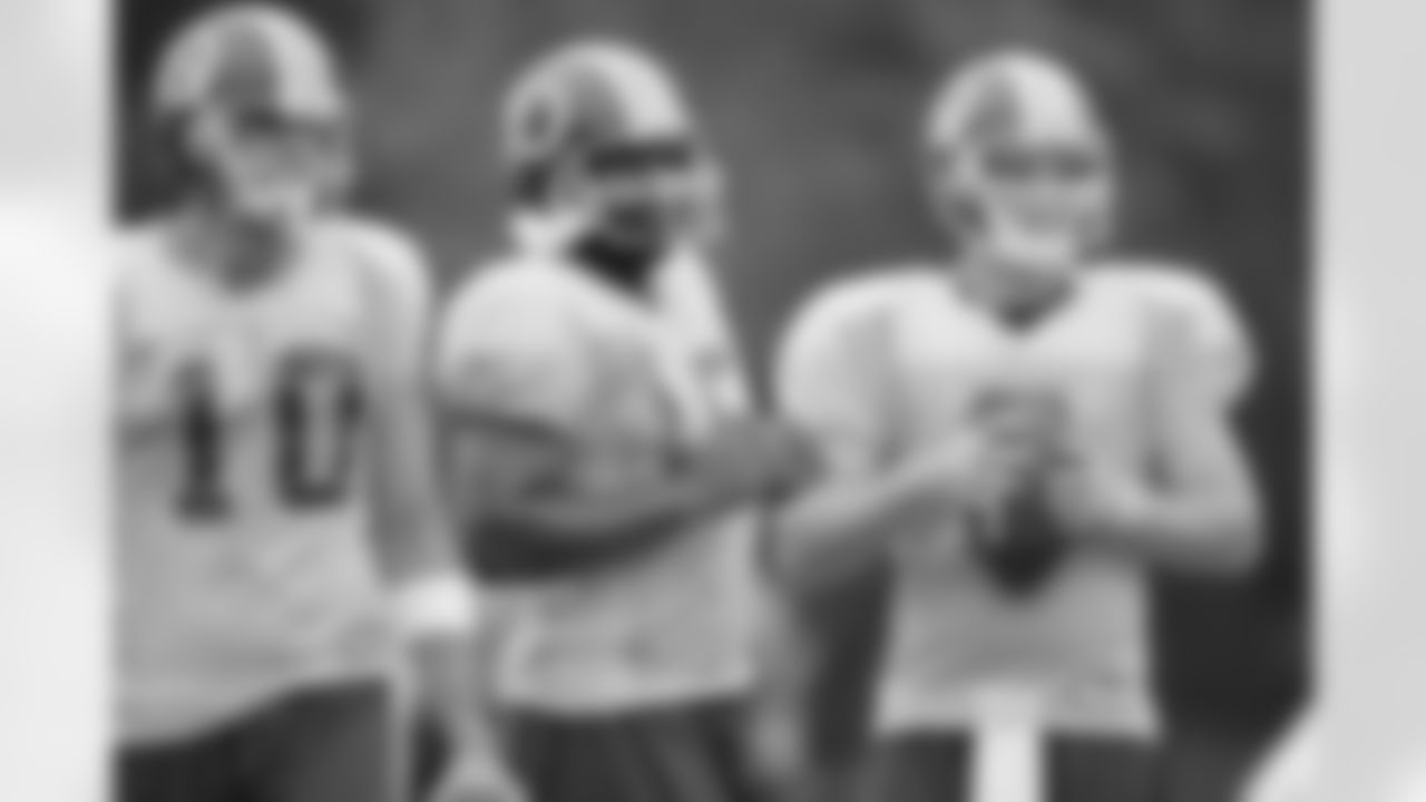 Three of the quarterbacks meeting during practice (AP Photo)
