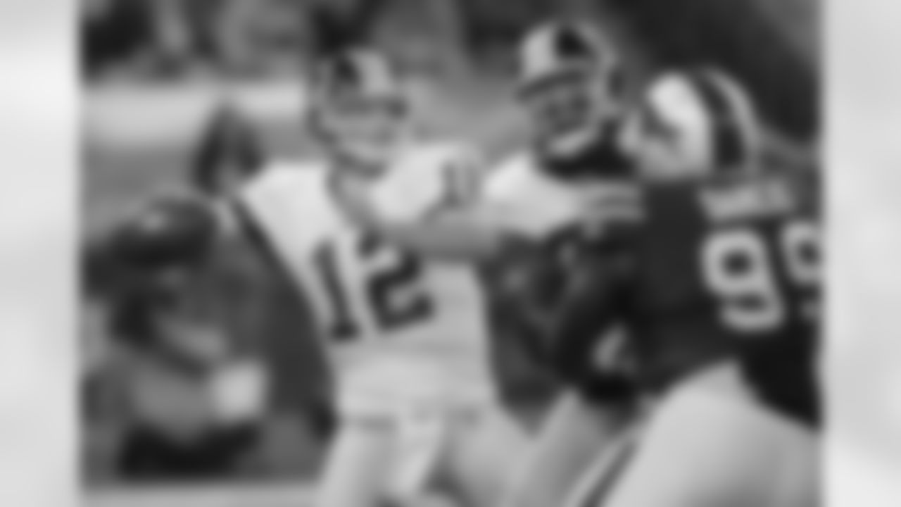 John Beck targets a receiver downfield.