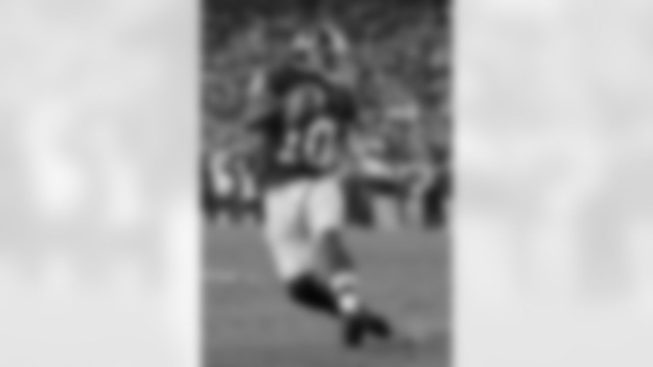 Redskins QB Robert Griffin III looks to elude defenders as he scrambles from the pocket.