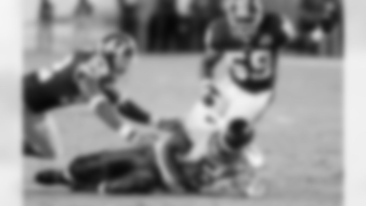 Redskins linebacker London Fletcher gets pressure on Eagles quarterback Donovan McNabb leading to a sack.