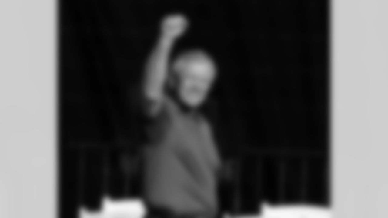 Joe Gibbs raises his fists to the Redskins fan-filled stadium.