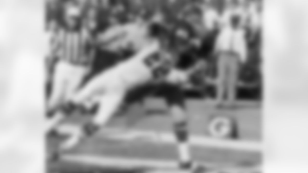 Washington?s Bob Mitchell, 49, pulls in a Sonny Jurgensen pass, in the last minute of NFL game on Sunday, Oct. 15, 1967 in Atlanta between the Redskins and the Atlanta Falcons to score, in spite of the efforts of Lee Calland, 22. The play pouts the Redskins ahead 20-17. The Falcons tied cup the Game with a field goal with two second left on the clock. (AP Photo/BJ)