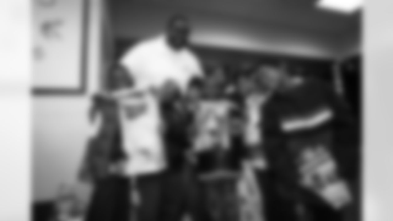 Offensive Lineman Isaiah Ross takes a picture with a group of children and their new toys.
