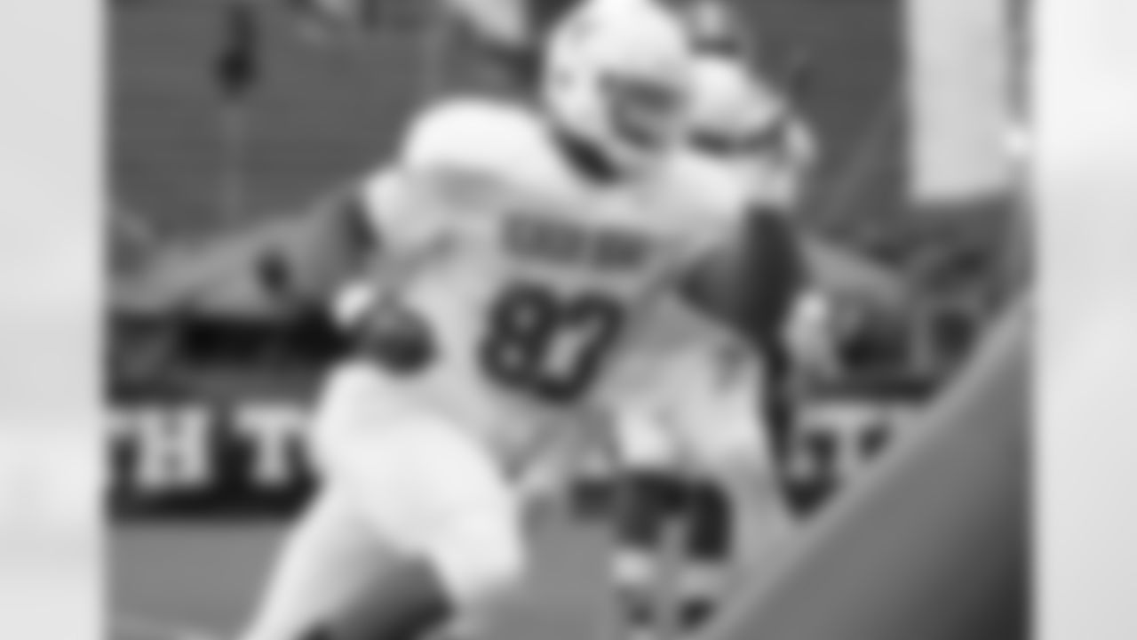 Texas defensive lineman Kheeston Randall bursts around a blocking dummy.