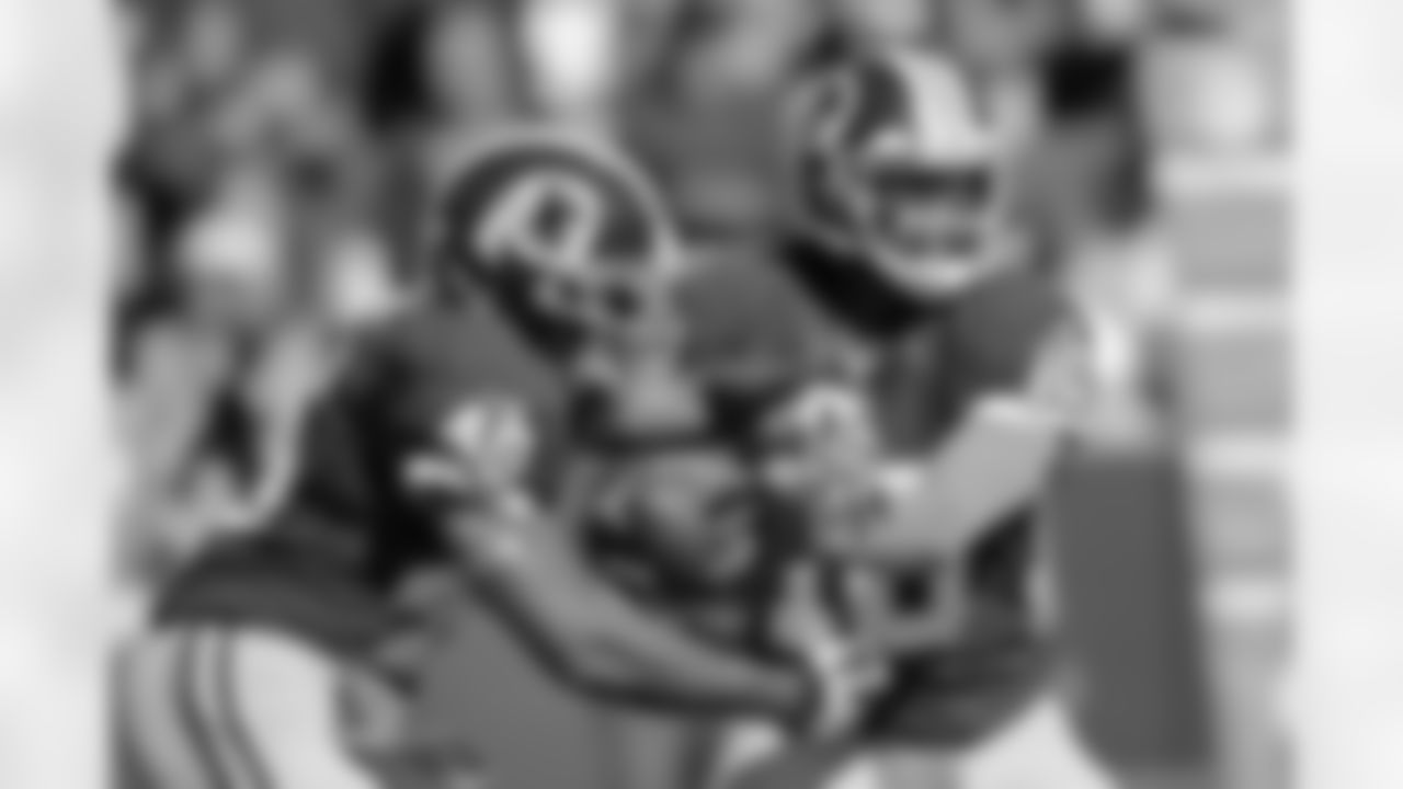 No. 6- Redskins quarterback Robert Griffin III reads the defense as he chooses to keep or hand the ball off to running back Alfred Morris.