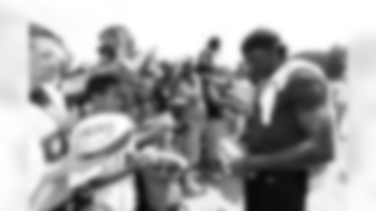 Redskins QB Robert Griffin III signs autographs for fans on Fan Appreciation Day.