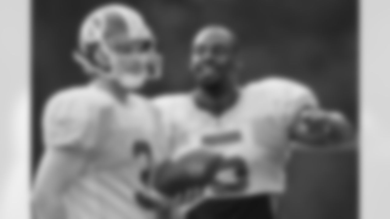 Quarterbacks John Beck and Donovan McNabb talk plays at camp (AP Photo)