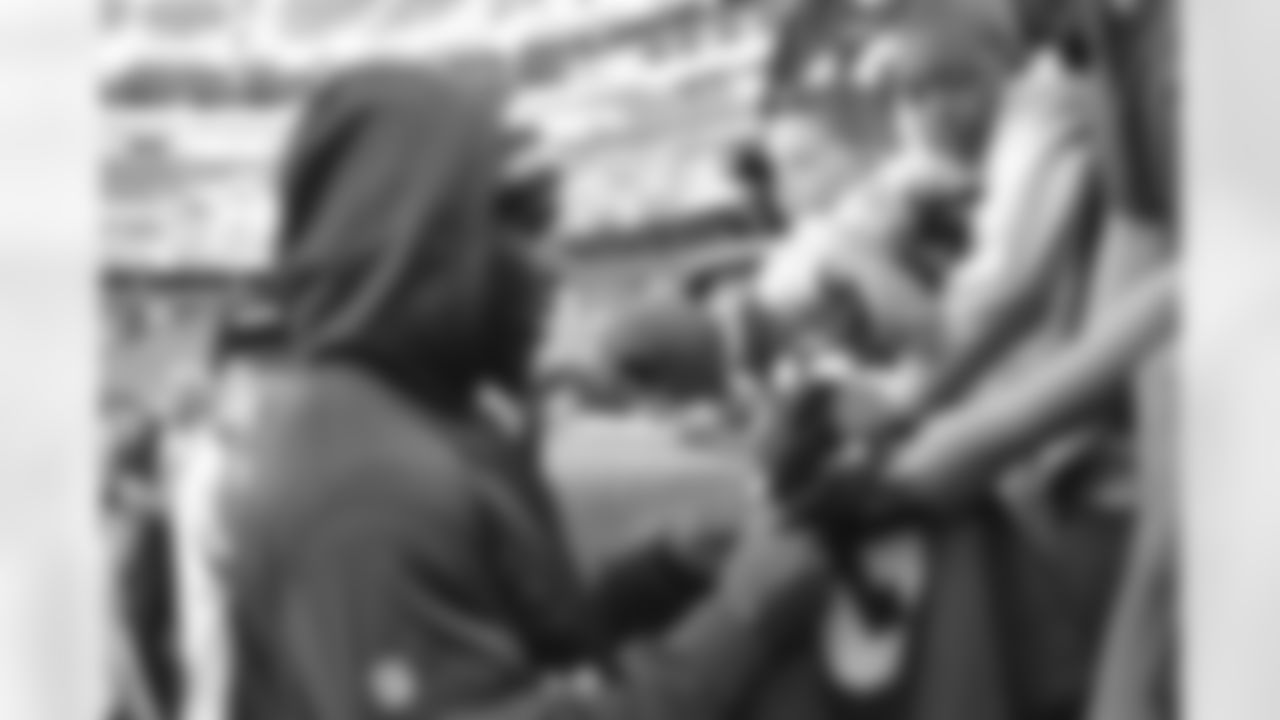 Redskins players signing autographs for fans before the game.