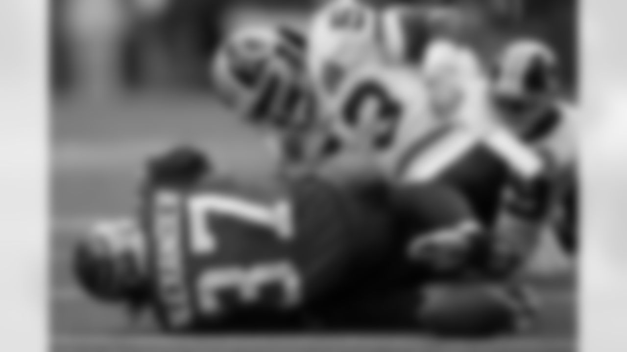Marcus Washington tries to force a fumble, but Shaun Alexander is ruled down.