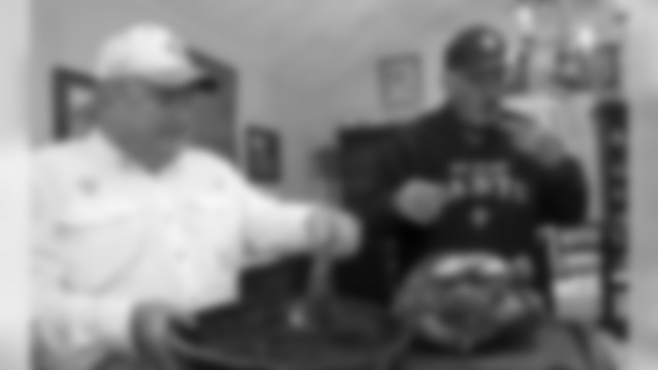 The extended Binnings and Ogden families celebrate Thanksgiving and watch the Saints game in Covington, Louisiana, November 22, 2018. Host Mike Binnings, left, and Richard Cahanin prepare to carve up the bird. (Photo by G. Andrew Boyd)