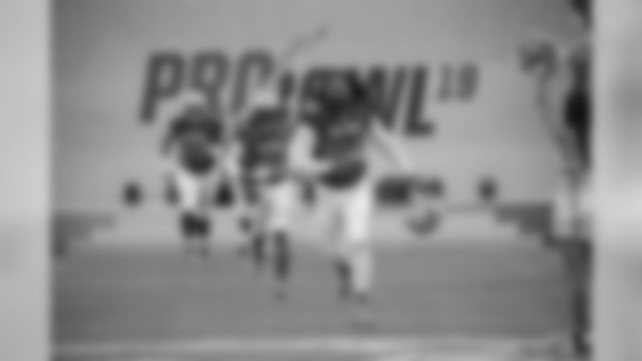 NFC defensive end Cameron Jordan (94), running back Alvin Kamara (41) and offensive guard Andrus Peat (75), of the New Orleans Saints, run onto the field during player introductions before the NFL Pro Bowl football game against the AFC Sunday, Jan. 27, 2019, in Orlando, Fla. (AP Photo/Phelan M. Ebenhack)