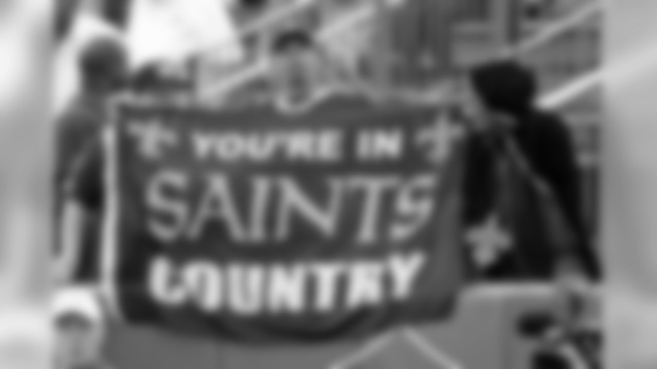 Fans wave a flag as the New Orleans Saints hold a 2019 training camp practice at Tulane University's Yulman Stadium on Sunday evening, August 4, 2019.