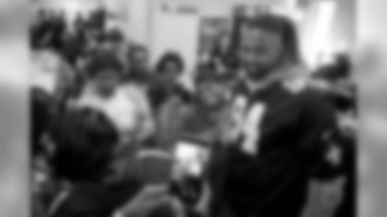 New Orleans Saints defensive end Cameron Jordan visits with students enjoying a Thanksgiving dinner courtesy of the Dudley DuBosier law firm at the Youth Empowerment Project adult education center on Tuesday, November 19, 2019.