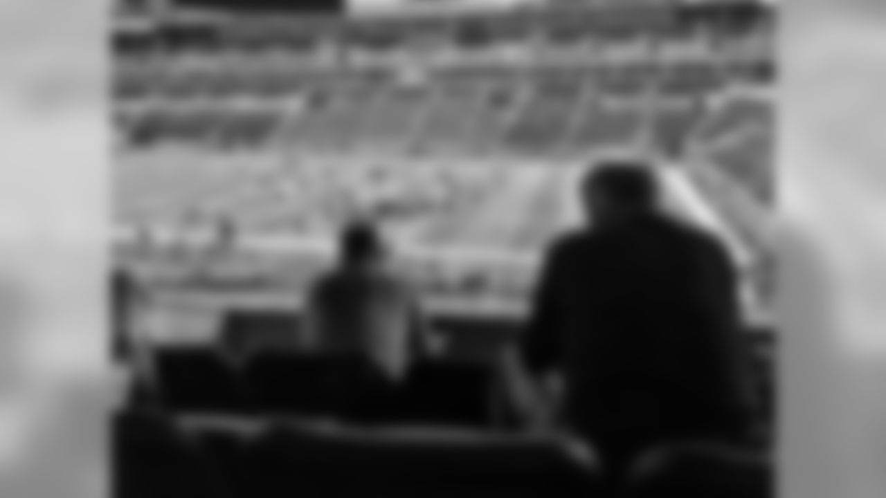 Sean Payton and Mickey Loomis sit in the team's suite at the 2016 NFL Combine.