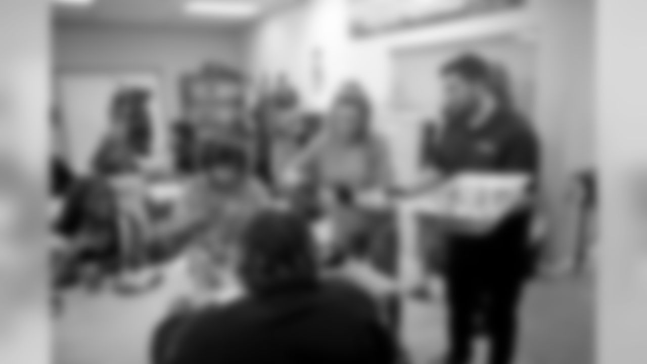 New Orleans Saints defensive end Cameron Jordan visits with students enjoying a Thanksgiving dinner courtesy of the Dudley DuBosier law firm at the Youth Empowerment Project adult education center on Tuesday, November 19, 2019.