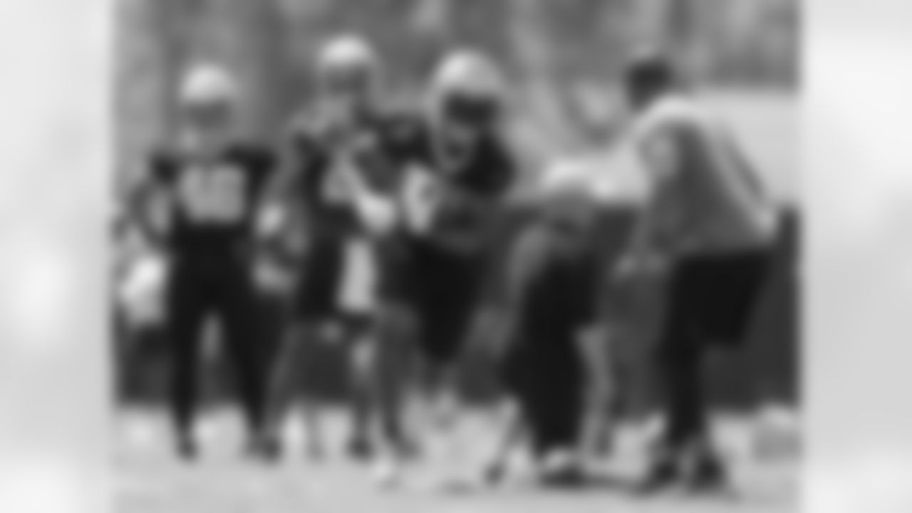 New Orleans Saints running back Dwayne Washington runs around a coach during a drill at the team's 2022 OTA practices on June 2, 2022 at the Ochsner Sports Performance Center.