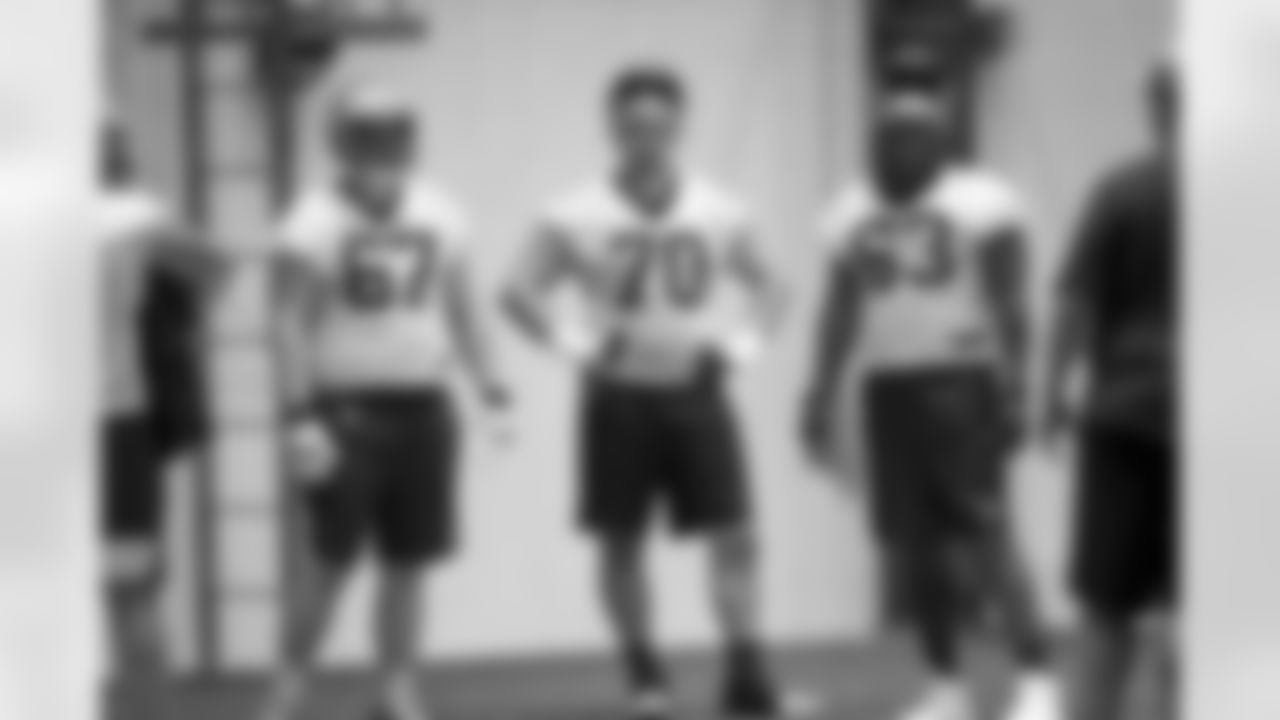 New Orleans Saints offensive linemen Landon Young, Trevor Penning, and Jerald Hawkins listen to offensive line coach Zach Strief at the team's 2022 OTA practices on May 25, 2022 at the Ochsner Sports Performance Center.