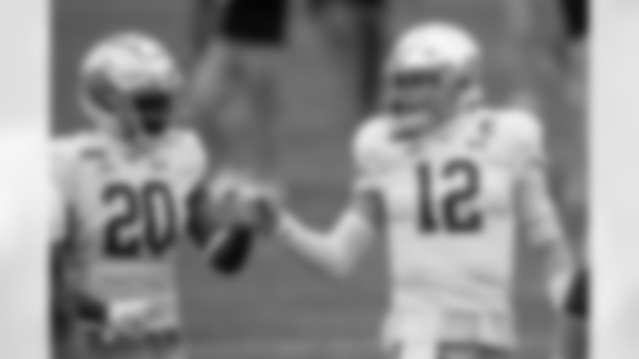 Notre Dame quarterback Ian Book (12) greets running back C'Bo Flemister (20) during warmup before an NCAA college football game against Pittsburgh, Saturday, Oct. 24, 2020, in Pittsburgh. (AP Photo/Keith Srakocic)