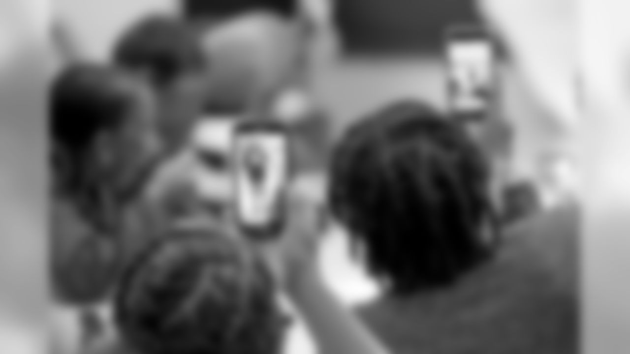 New Orleans Saints defensive end Cameron Jordan visits with students enjoying a Thanksgiving dinner courtesy of the Dudley DuBosier law firm at the Youth Empowerment Project adult education center on Tuesday, November 19, 2019.