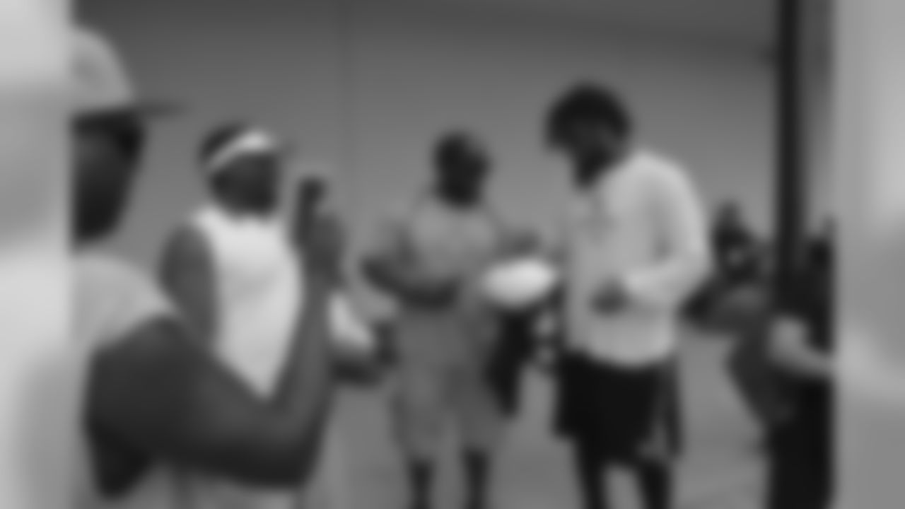 Saints head coach Sean Payton surprised two fans at Wednesday's open practice with a unique experience. Terry Gaddison Jr. and Rachel Masters joined the team on the field for a pre-challenge coin flip, group photo and autographs from the players.