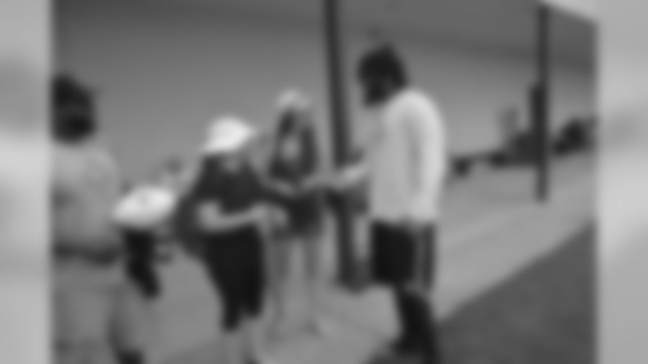 Saints head coach Sean Payton surprised two fans at Wednesday's open practice with a unique experience. Terry Gaddison Jr. and Rachel Masters joined the team on the field for a pre-challenge coin flip, group photo and autographs from the players.