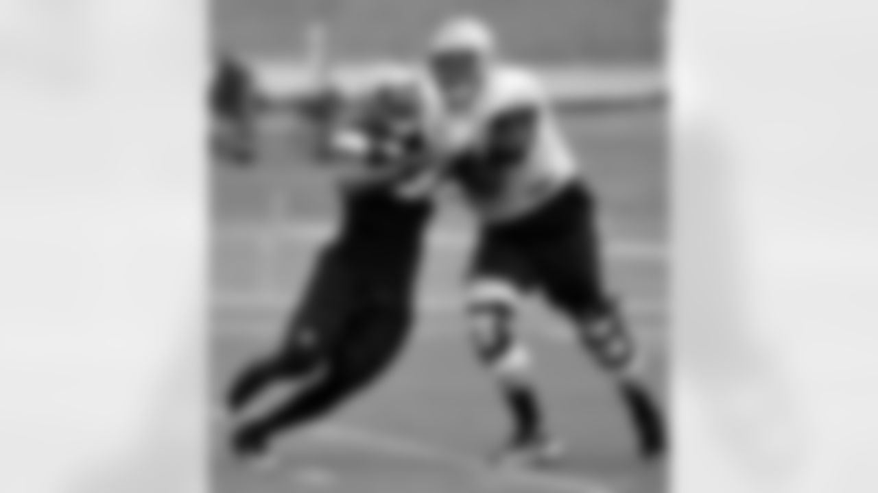 New Orleans Saints outside linebacker Parys Haralson (98) fights New Orleans Saints tackle Zach Strief (64) in a blocking drill to protect to quarterback during the team's NFL football training camp in White Sulphur Springs, W. Va., Thursday, Aug. 6, 2015. (AP Photo/Chris Tilley)